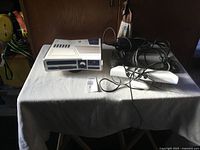 Front and top views of the limited edition Star Wars Xbox 360 console with Kinect and wired controller on a white cloth surface.