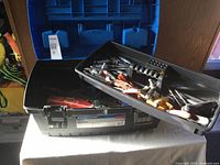 View of open toolbox with removable tray containing various hand tools like screwdrivers, pliers, and small hand tools.