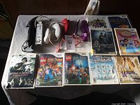 Overview of all Wii controllers and game cases arranged on a table