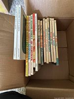 Top view of vintage children's books showing titles including Sesame Street storybooks and Dr. Seuss titles.