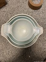 Top view of the three nested Pyrex Cinderella mixing bowls showing their sizes and shape.