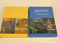 Front view of the two hardcover art books side by side: Van Gogh on the left with yellow cover, Monet on the right with blue cover.