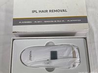 White Yundao branded IPL hair removal device inside molded plastic packaging within original IPL Hair Removal box.