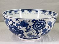 Side view of the large Chinese blue and white porcelain bowl showing floral patterns on the exterior.