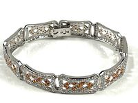 Full view of the linked sterling silver bracelet with multiple rectangular segments featuring clear and pink crystals.