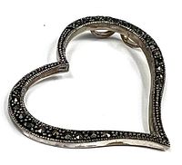 Close-up photo showing the detailed beaded edge and dark crystals embedded along the heart-shaped sterling silver pendant.