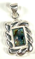 Front view of sterling silver pendant showing iridescent inlay and twisted rope border design.