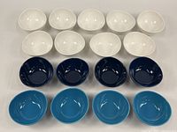 Overview of all 17 Sweese oblong porcelain bowls in white, dark blue, and light blue colors arranged on table.