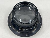 Front view of Kodak Ektanon projection lens showing engraved details on the glass and aperture scale.