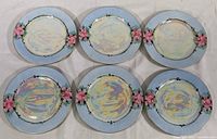 Six vintage Felda China dessert plates shown in a set. Plates have a blue rim with pink roses and iridescent centers.