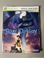 Front cover of Blue Dragon Xbox 360 Official Game Guide showing game characters and title.