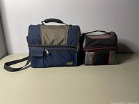 Two lunchboxes side by side: larger Dakota Workpro Series and smaller kids lunch bag