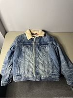 Front view of medium American Eagle denim jean jacket showing sherpa collar and button closure.