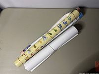 Rolled posters including some with cartoon images and others in blue hues.