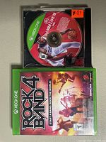 Rockband 4 game case front cover and NBA Live 19 disc on top of it.
