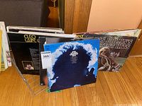 Photo showing multiple vinyl records in a rack including Bob Dylan, Cleo Laine & Johnny Dankworth, Janis Joplin's Greatest Hits.