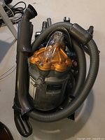 Overall view of vacuum with hose and handle