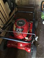 Front/top view showing red deck, Briggs & Stratton engine cover with Craftsman branding and fuel cap