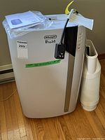 Full view of unit with manual on top and exhaust hose beside