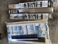 Two unopened Holmes gutter cover units, each 20 linear feet long, showing packaging and product labels with instructions and product details.