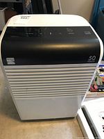 Front view of Kenmore dehumidifier showing control panel and 50 pint capacity marking.