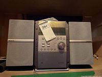 Front view of Panasonic mini stereo system with two speakers and manual on top