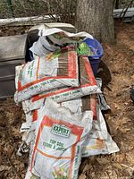Stack of multiple white bags labeled Expert Gardener Top Soil 22L each