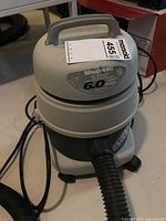Shop Vac wet dry vacuum showing top handle, brand label, and specification of 6.0 amps