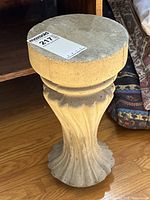 Full view of stone pedestal podium showing its shape and design.