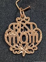 Front angled view of the 10KT Gold 'Blessed Mom' pendant showing detail of the design and weight indication.