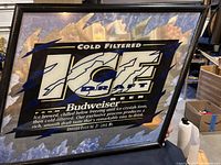 Framed Budweiser Ice Draft Beer mirror with logo and text, reflecting surrounding area. Displaying condition and design.