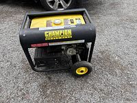 Front-side view showing open frame, wheels, tank top and Champion Heavy Duty label