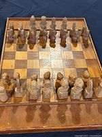 Top view of the chessboard with all chess pieces positioned along two opposite sides, showing the full layout and detail of pieces and board.
