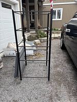 Front view of the assembled heavy duty steel shelving frame showing black steel tubular structure with multiple horizontal bars for shelf support.