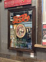 Front view of the large vintage Pepsi Cola mirror displaying its advertising graphics and wood frame.