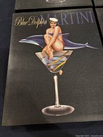 Photo showing 'Blue Dolphin Martini' image of a pin-up woman on martini glass with dolphin.