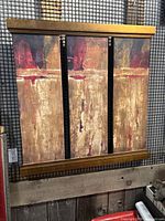 Front view of the modern art canvas print with wood frame hanging on a grid wall.