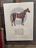 Full view of the laminated Mumford & Sons tour poster mounted on board featuring the outlined horse illustration with text beneath.