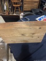 Side view of the wooden box showing the Tignish Fisheries LTD COD trimming label and natural wood grain.