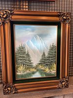 Frontal view of the original oil painting showing mountain landscape and ornate frame