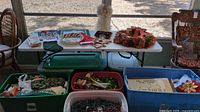 Photo showing table with wreaths, storage bins, various decorations including plates, napkins, and lights.