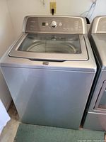 Frontal view of Maytag Bravos X washer showing full unit next to matching dryer