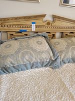 Close-up of Grecian motif patterned bedding on the bed