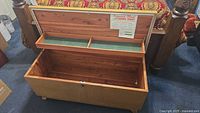 Open cedar chest showing lined top tray with green felt and a large storage compartment beneath