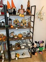 Black metal frame bookshelf with four wooden shelves arranged with decorations. Photos from different angles show the movable shelving and rustic wood shelves.