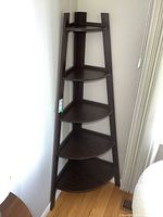 Full view of the dark wood corner etagere shelf showing all five levels and triangular shelves.
