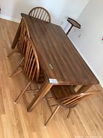 Full view of table with four chairs and bench