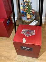 Photo of Disney Showcase Collection box with original packaging in red and purple colors showing branding and series name.