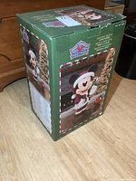 Photo of the original green box showing the front with an image of the Holiday Mickey Mouse figurine and branding.