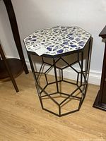 Angle showing the top mosaic surface and octagon shape of the table.
